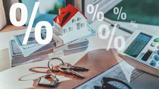 A composite image showing percentage signs, cash, a calculator, keys and a plastic model of a home.