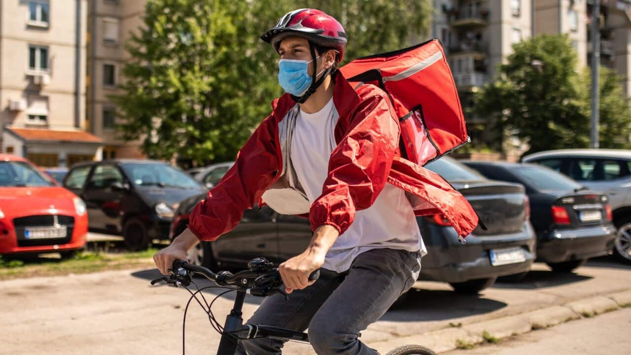 A delivery person on his working day to deliver whatever being ordered by the customer.