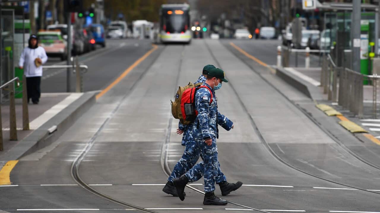 Royal Australian Air Force personnel patrol through the empty streets of Melbourne's CBD.