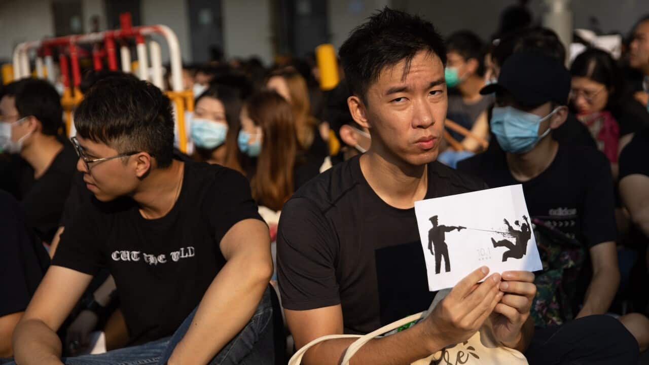 Protesters outside the Tsuen Wan Public Ho Chuen Yiu Memorial College during a demonstration held to show solidarity with an injured student, in Hong Kong