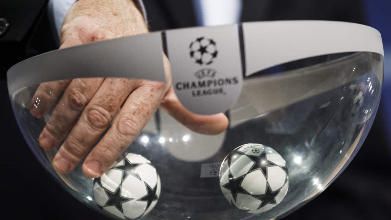 A UEFA official picks up a ball during the draw of the first two qualifying rounds of the UEFA Champions League 2015/16.
