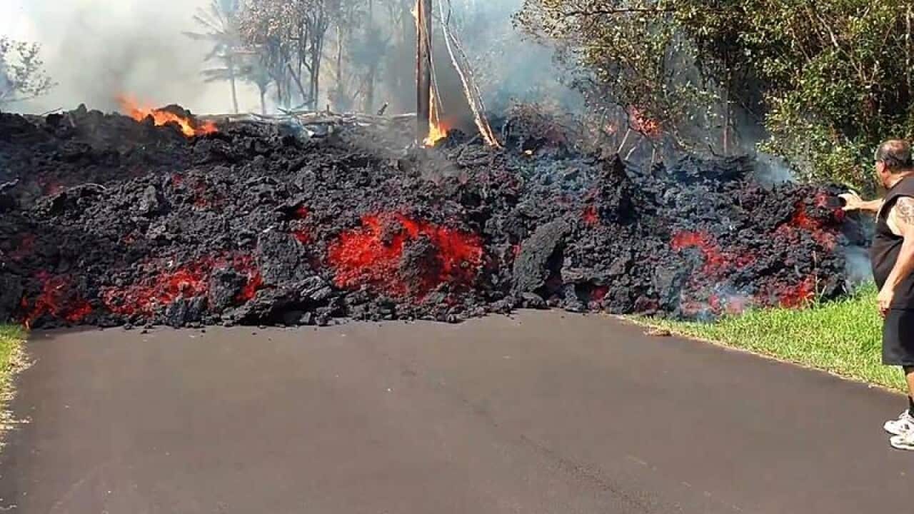 Lava flows down residential road in Hawaii