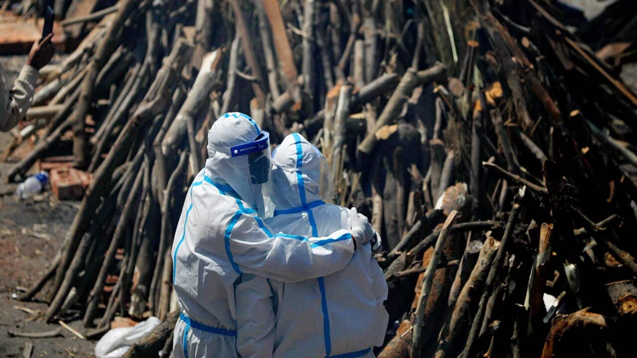 Relatives mourning next to pyres of Covid-19 deceased people at a crematorium in New Delhi.