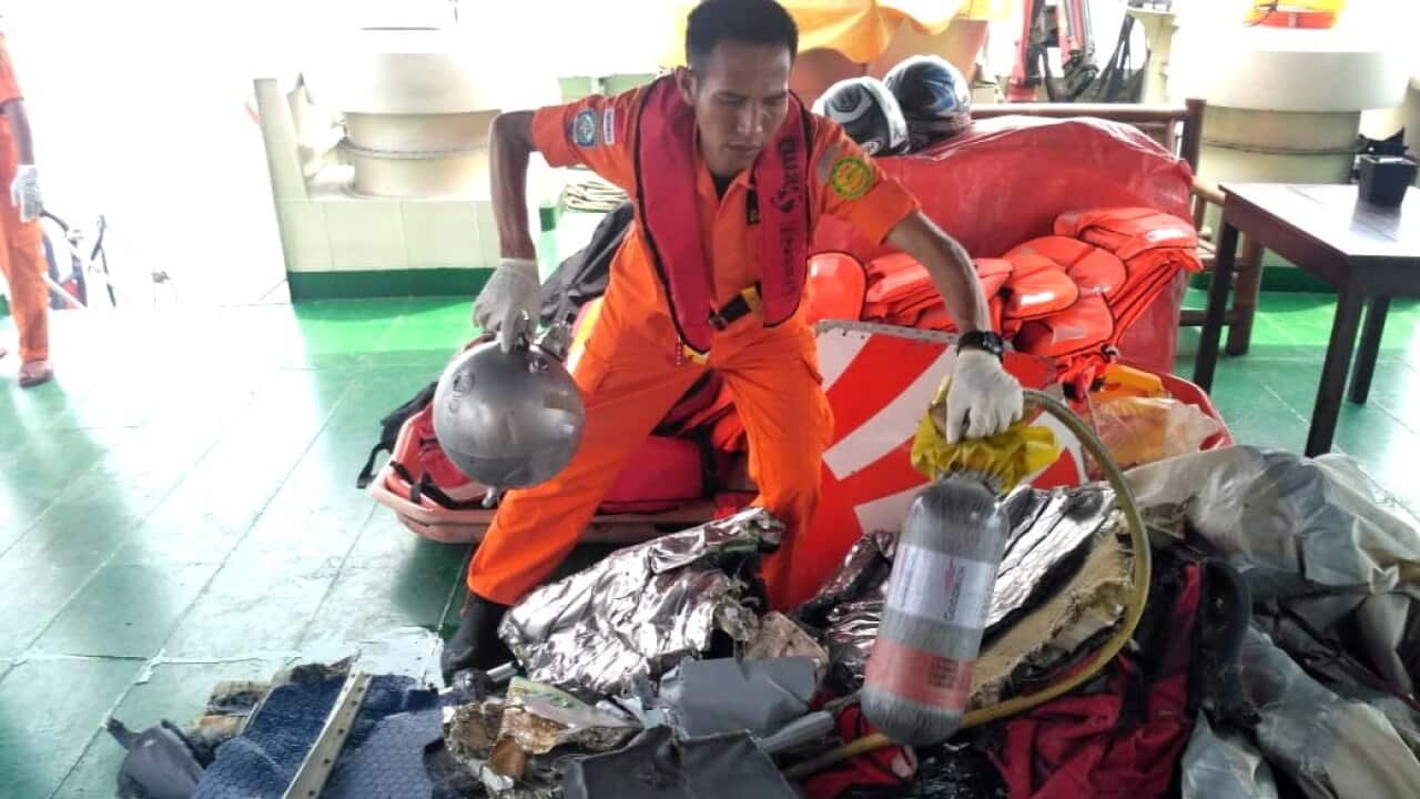 Indonesian rescuer moves parts from a crashed Lion Air passenger plane in waters off Tanjung Karawang, West Java.