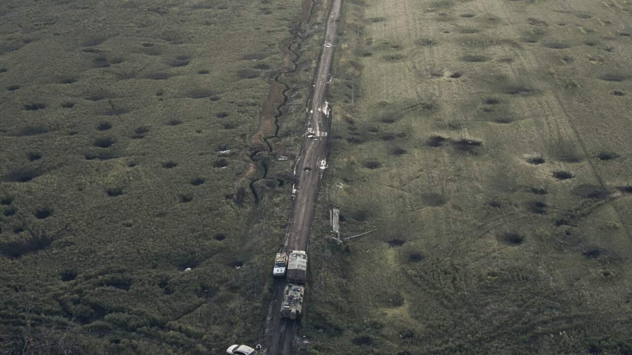 A field covered with craters left by the shelling close to Izium, Kharkiv region, Ukraine