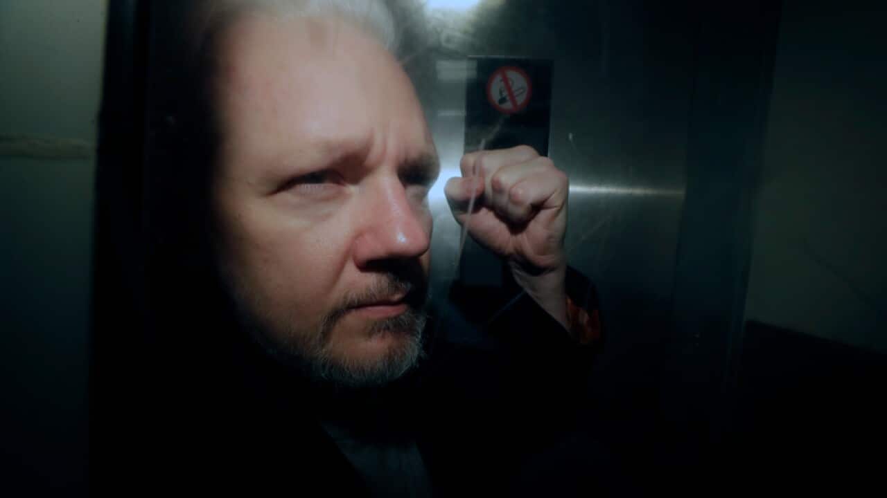 WikiLeaks founder Julian Assange puts his fist up as he is taken from court in London on May 1 2019.
