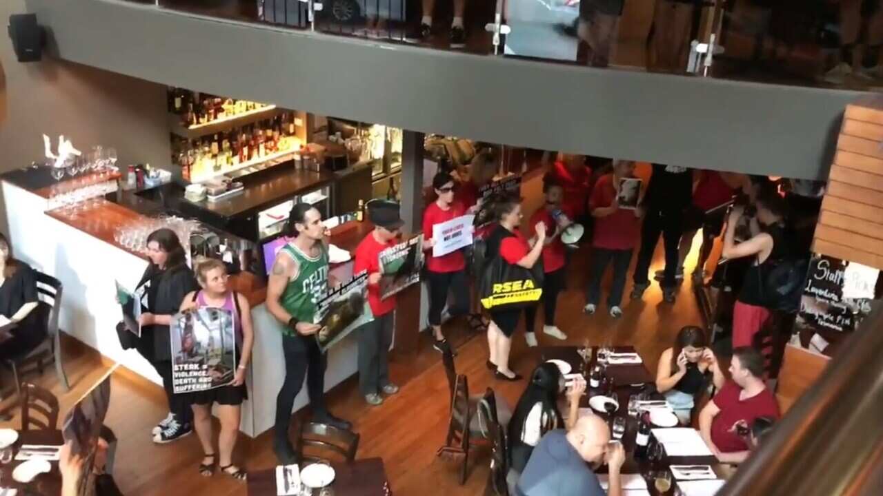 Protesters storm a Melbourne steakhouse.
