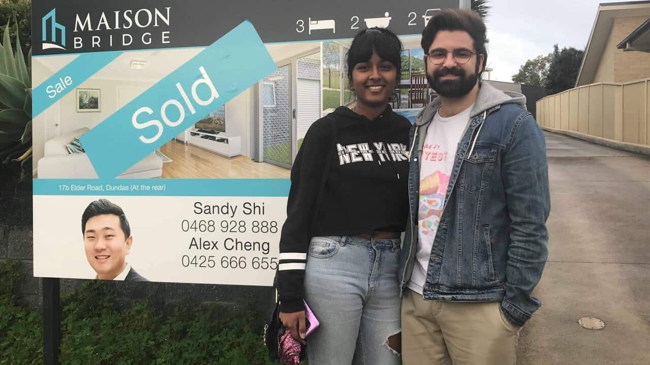 Nav, 24 years old, and her partner outside their newly purchased property
