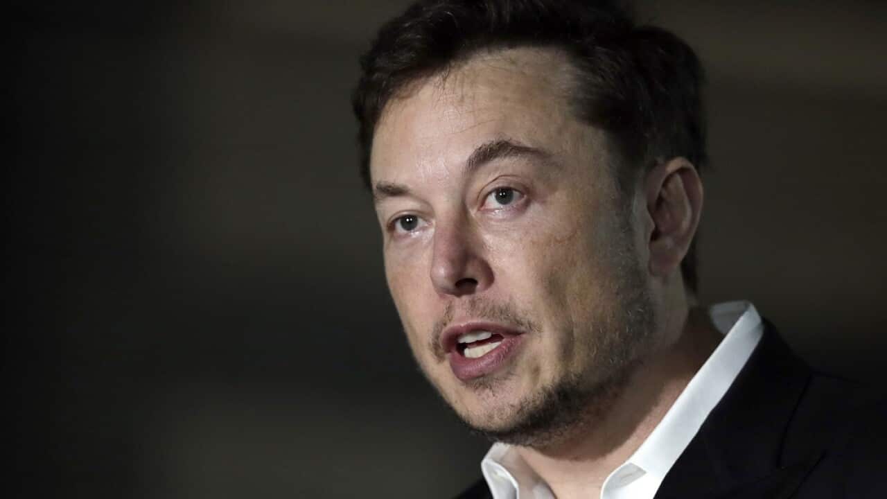 Elon Musk speaks at a news conference in Chicago.