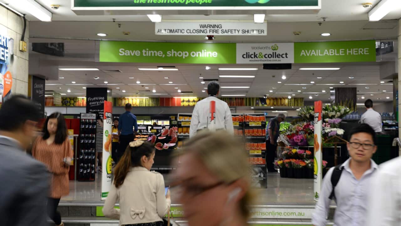 People walk past a Woolworths, Town Hall, Sydney.