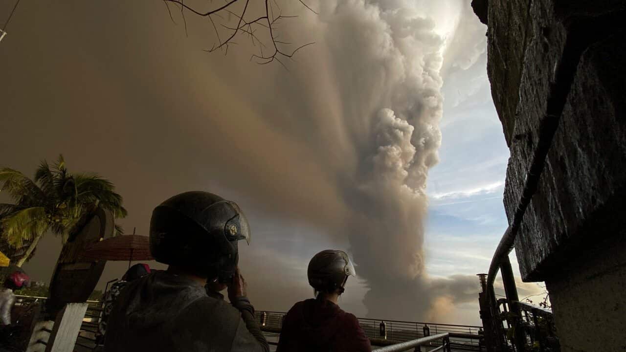 People watch from Tagaytay, Cavite province as Taal Volcano erupts Sunday 12 January 12, 2020.