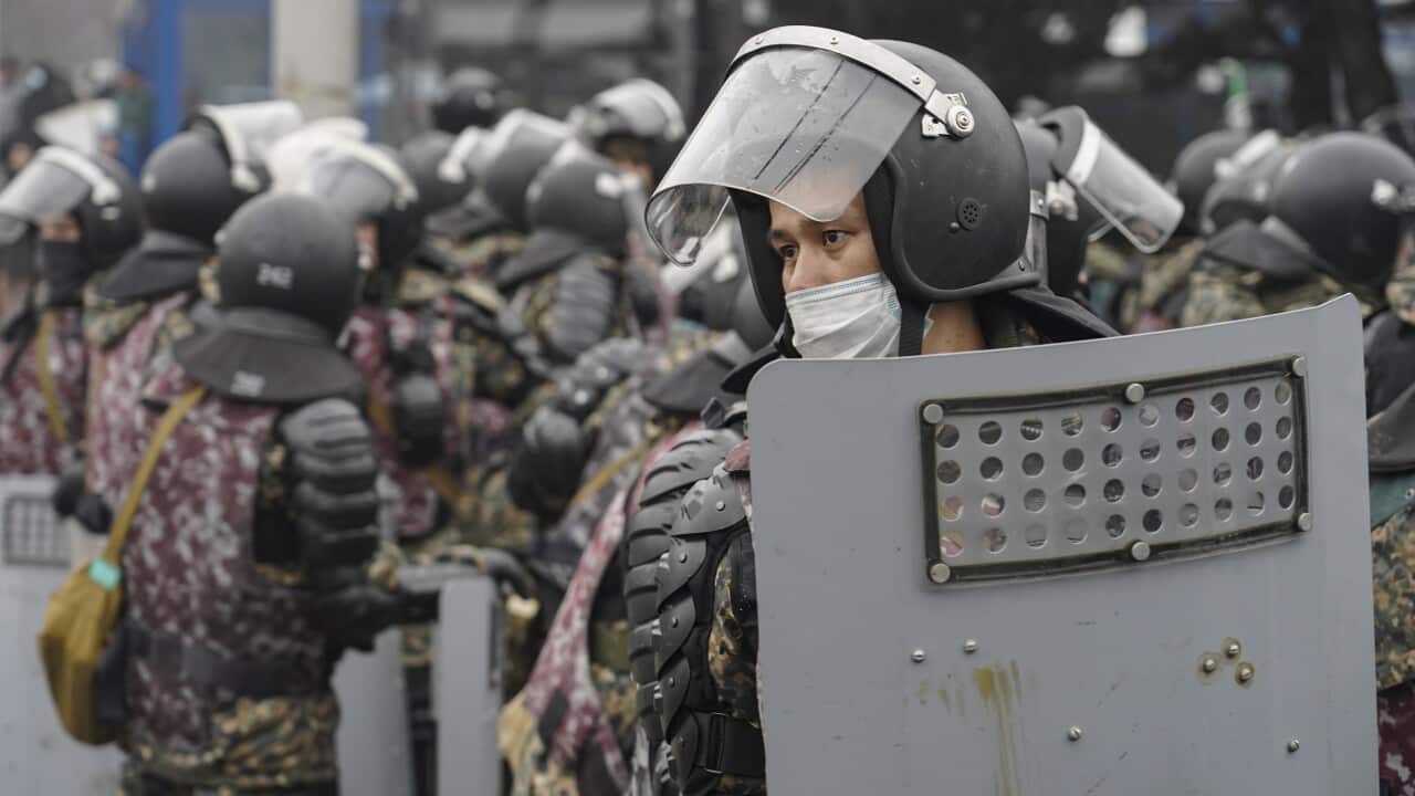 Kazakh policemen during protests over a hike in energy prices in Almaty