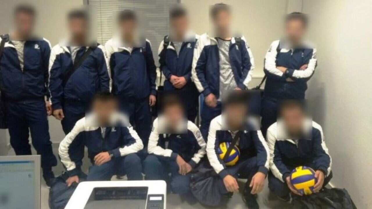 Greek police released a picture of the group in their outfits, holding two volleyballs.