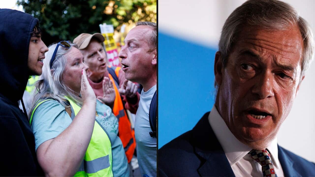 A man confronts another man with a woman intervening between them