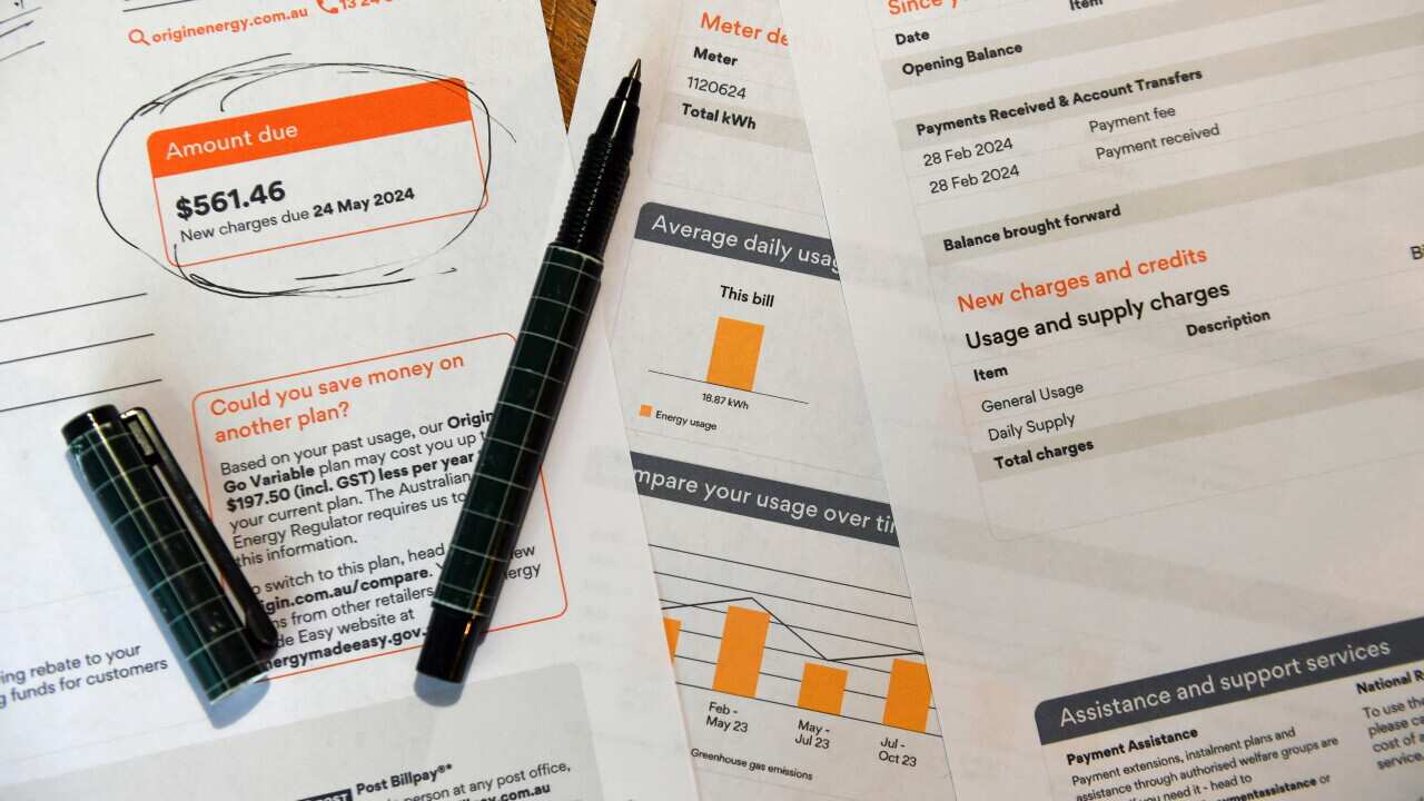An electricity bill on a desk with a pen.