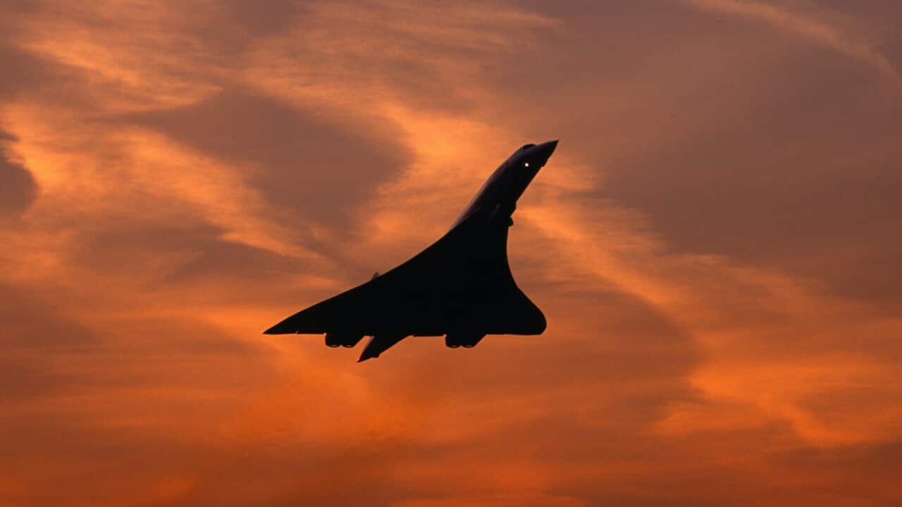 Silhouette of Concorde supersonic airplane against sunset sky
