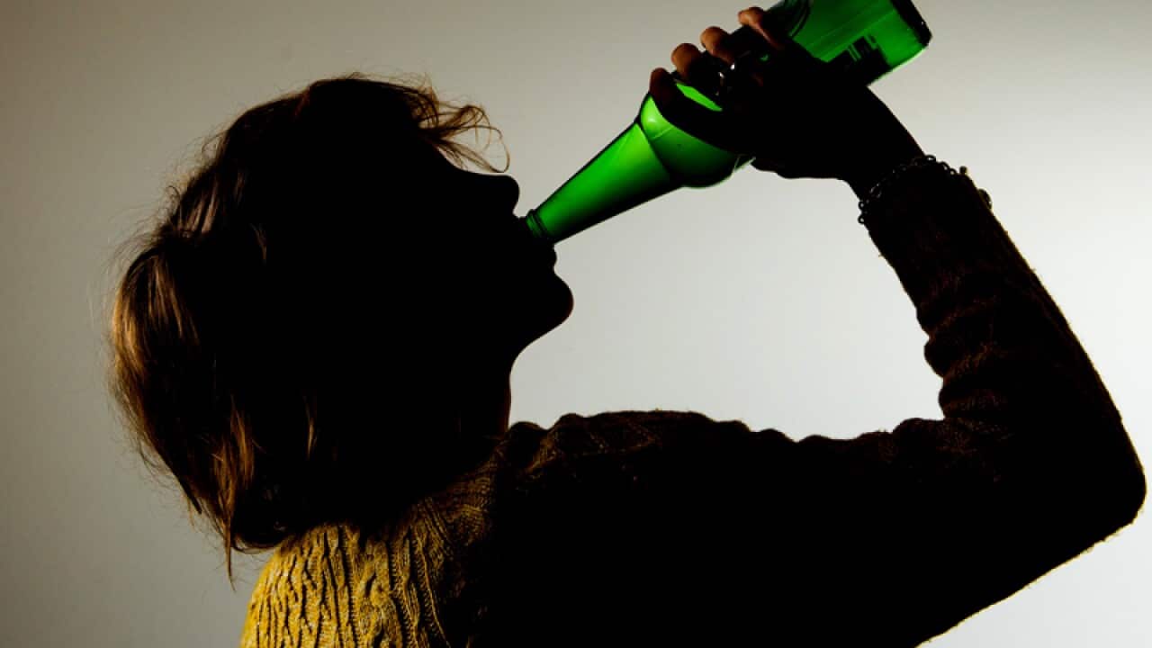 A woman drinking alcohol