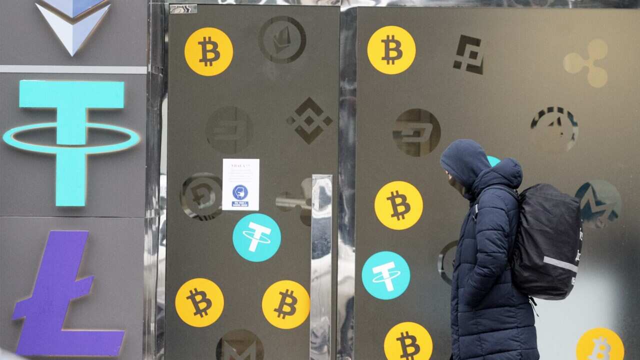 A man walks past a cryptocurrency exchange point in the center of Kyiv, Ukraine on 24 January 2022.