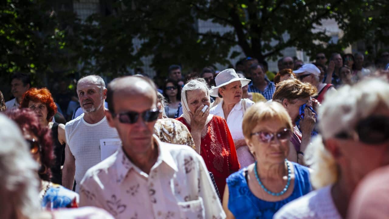 People mourn during a memorial service in Ukraine