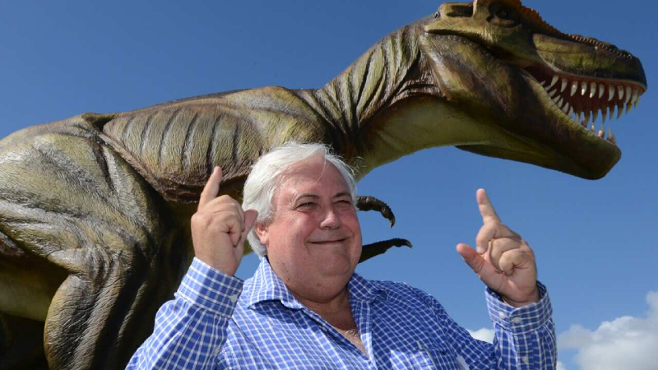 Clive Palmer posing for a photograph with Jeff the dinosaur