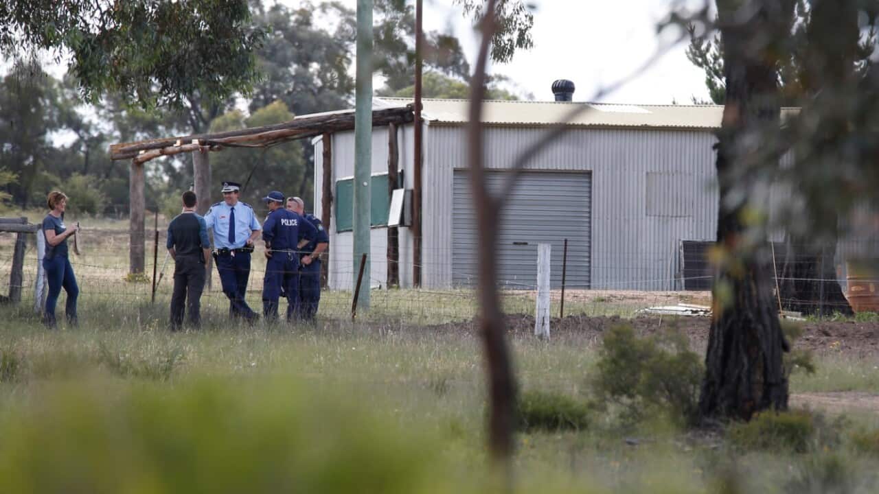 Police stand together chatting as they search property on Pinevale farm, where father and son Gino and Mark Stocco were arrested in 2015