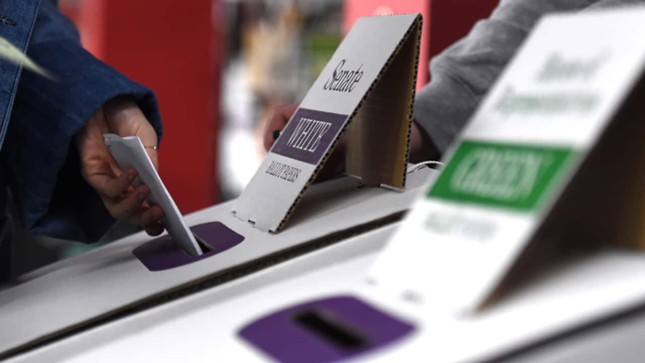 A voter casts their ballot