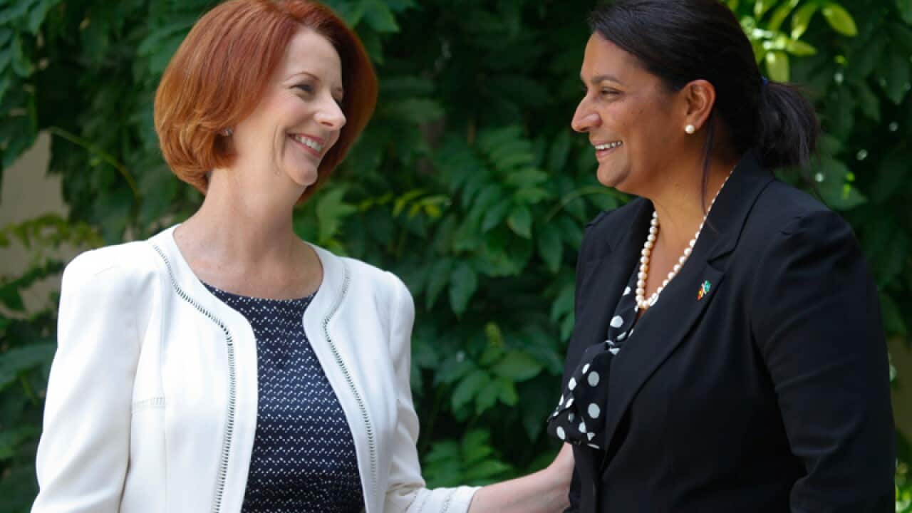 Former Olympic and Commonwealth Games medalist Nova Peris and Julia Gillard pose for photographs after a press conference where the former PM endorsed Peris as a candidate for the Senate in the Northern Territory in Canberra on 22 January 2013. (AAP)