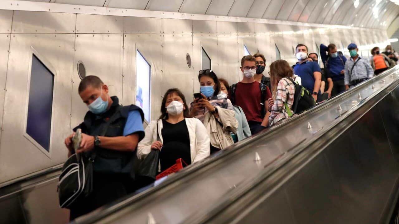 People wearing face masks ride an escalator in subway in Prague, Czech Republic, Thursday, 17 September, 2020.