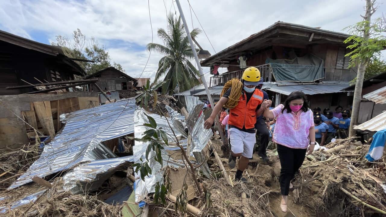 Vice-president Leni Robredo (R) inspecting a village in the typhoon devastated city of Bais