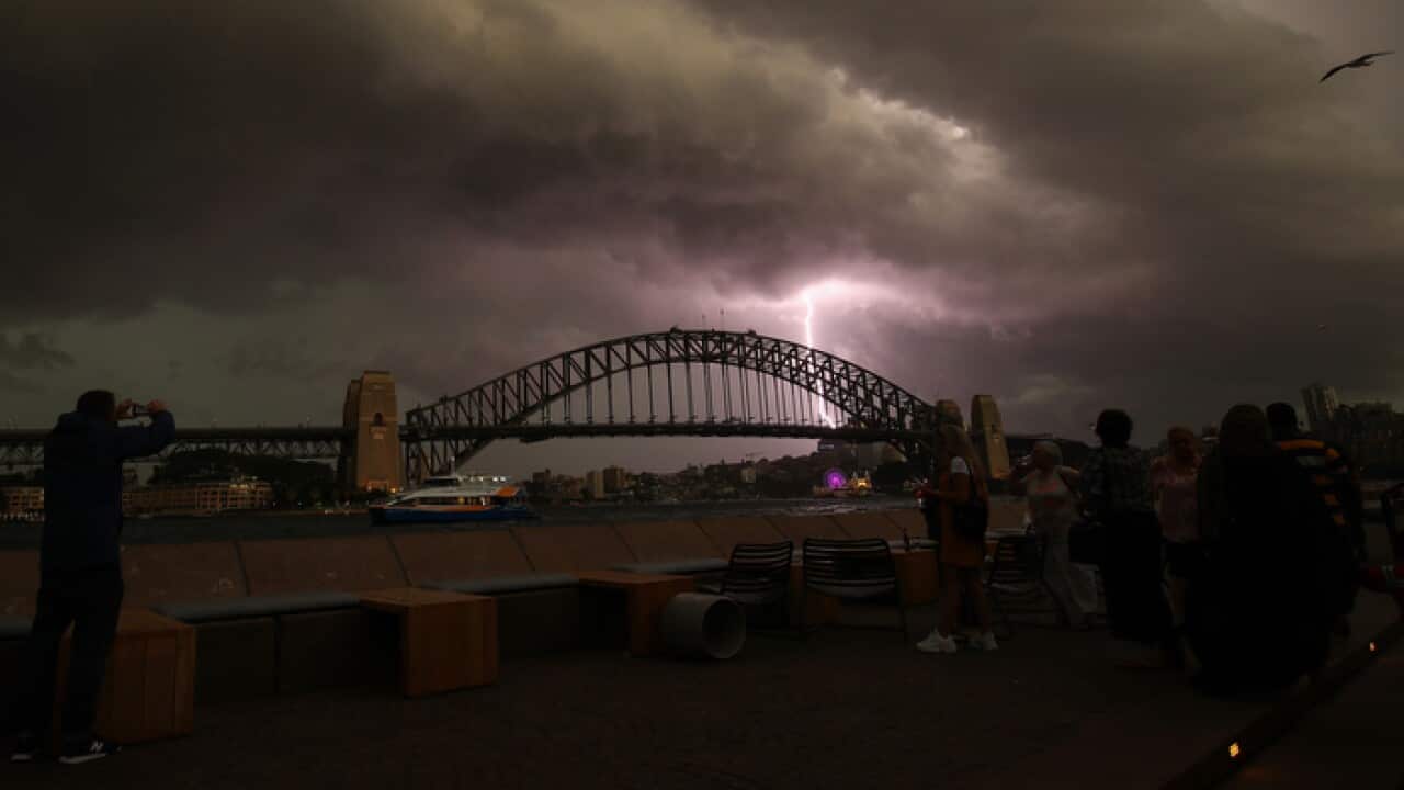 A lightning bolt strikes as a storm cell is seen above the Sydney Harbour Bridge in Sydney