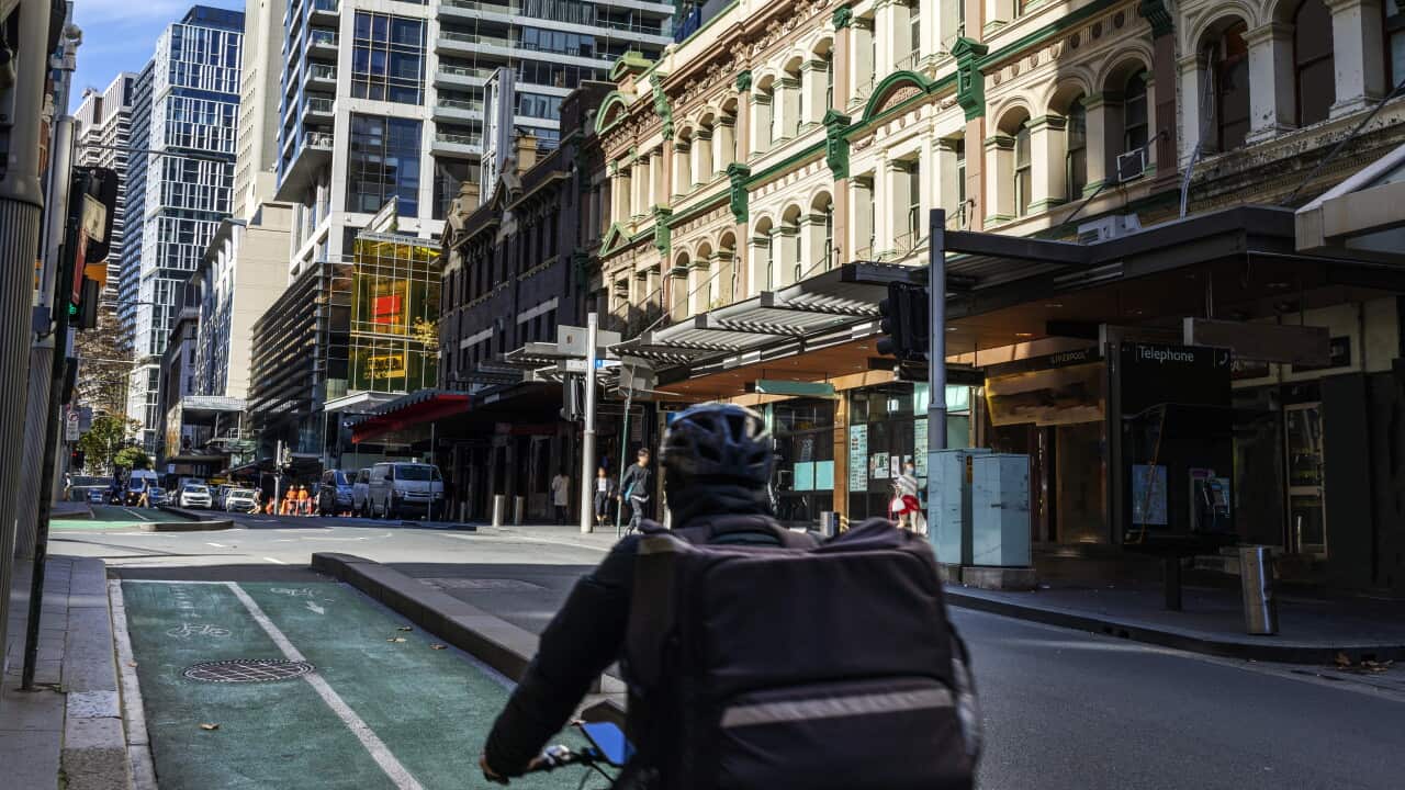 Food delivery bike driver cycling in bike lane in Sydney city