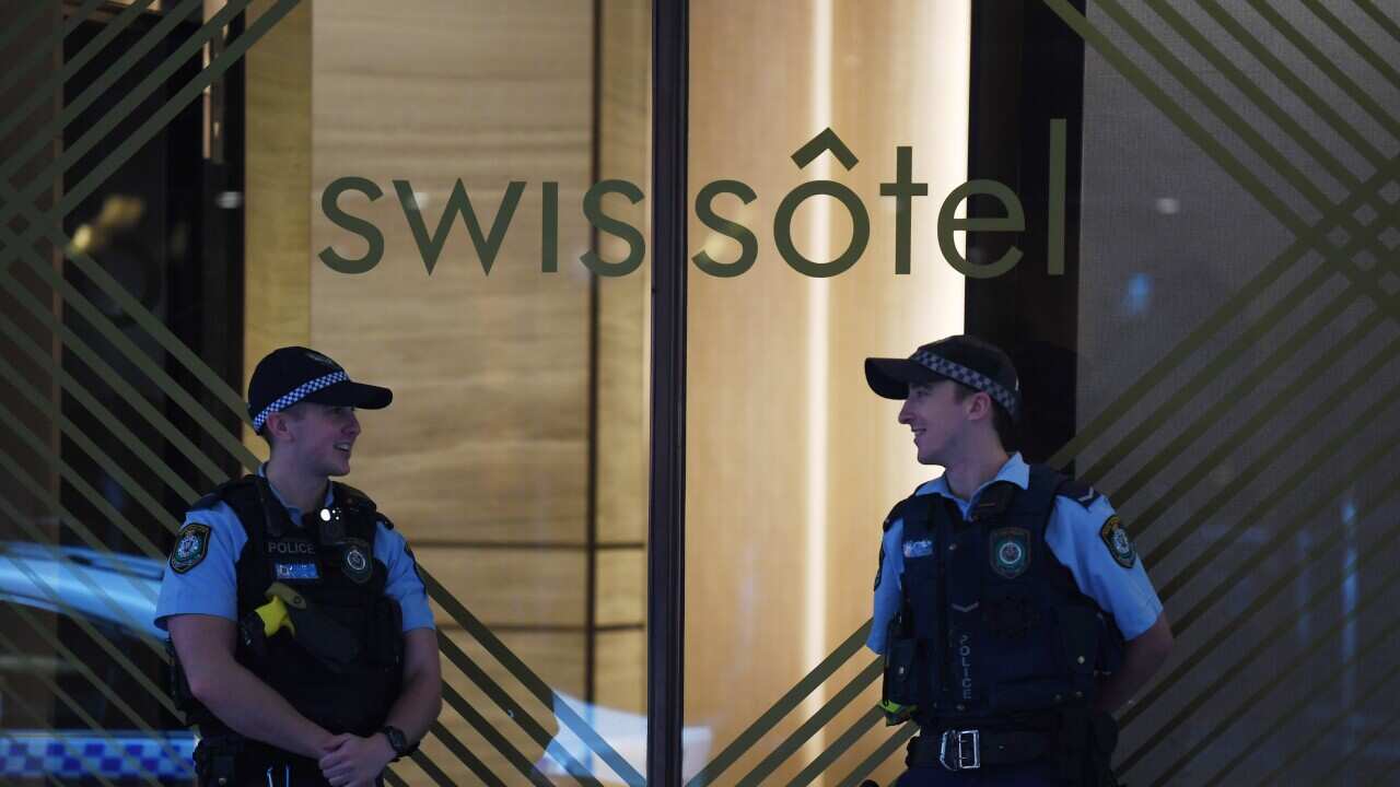 NSW Police stand guard outside the Swissotel Hotel in Market Street, Sydney.