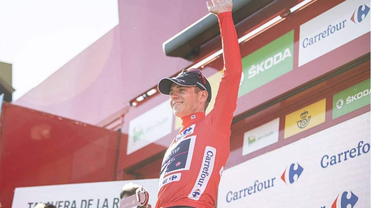 Remco Evenepoel receives the red jersey after Stage 19 of La Vuelta