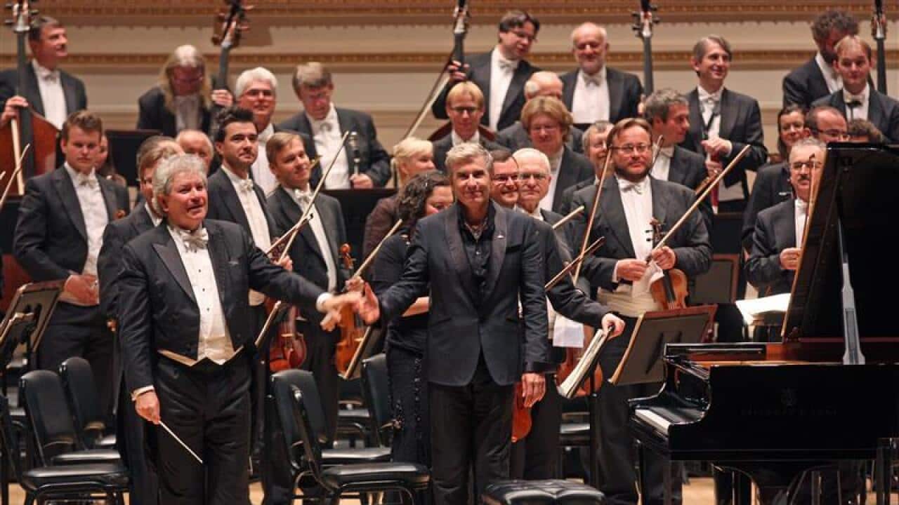 jean-Yves Thibaudet, center, performed Liszt's "Piano Concerto No. 2 in A Major" with the Czech Philharmonic led by Jiri Belohlavek, left.(Photo by Hiroyuki Ito/Getty Images)