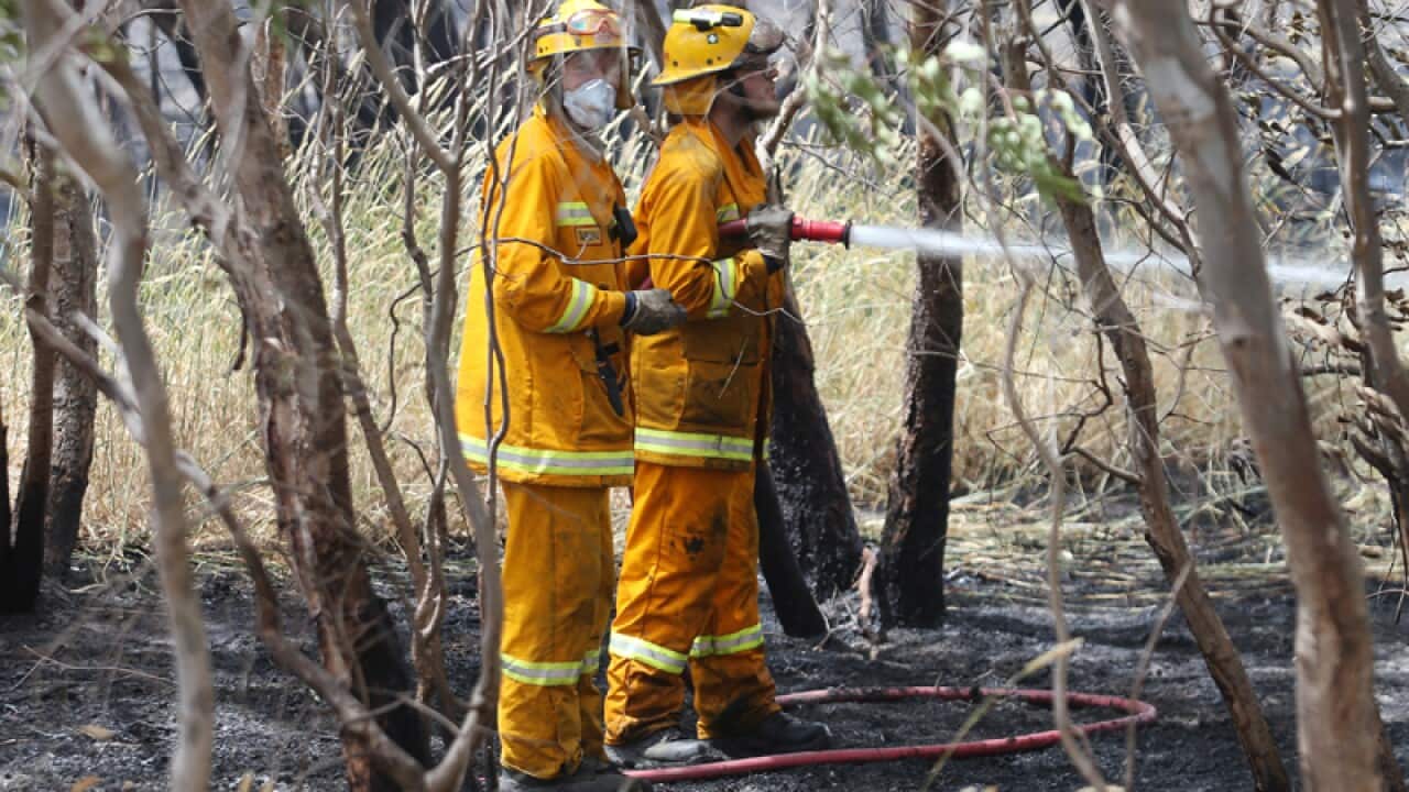 CFA firefighters mop up a fire near Mia Mia in Victoria