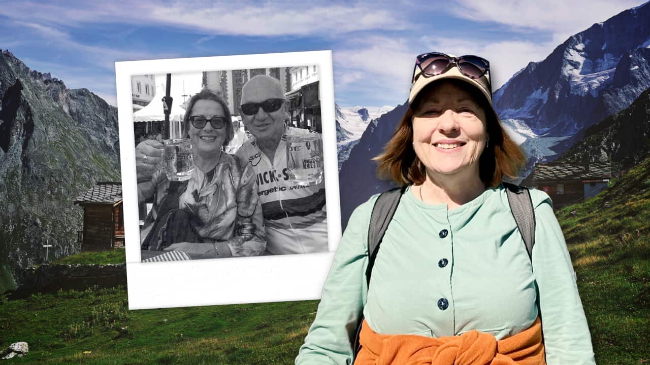 A woman smiling while wearing hiking gear. There are mountains in the background. A photograph of her and a man is next to her.