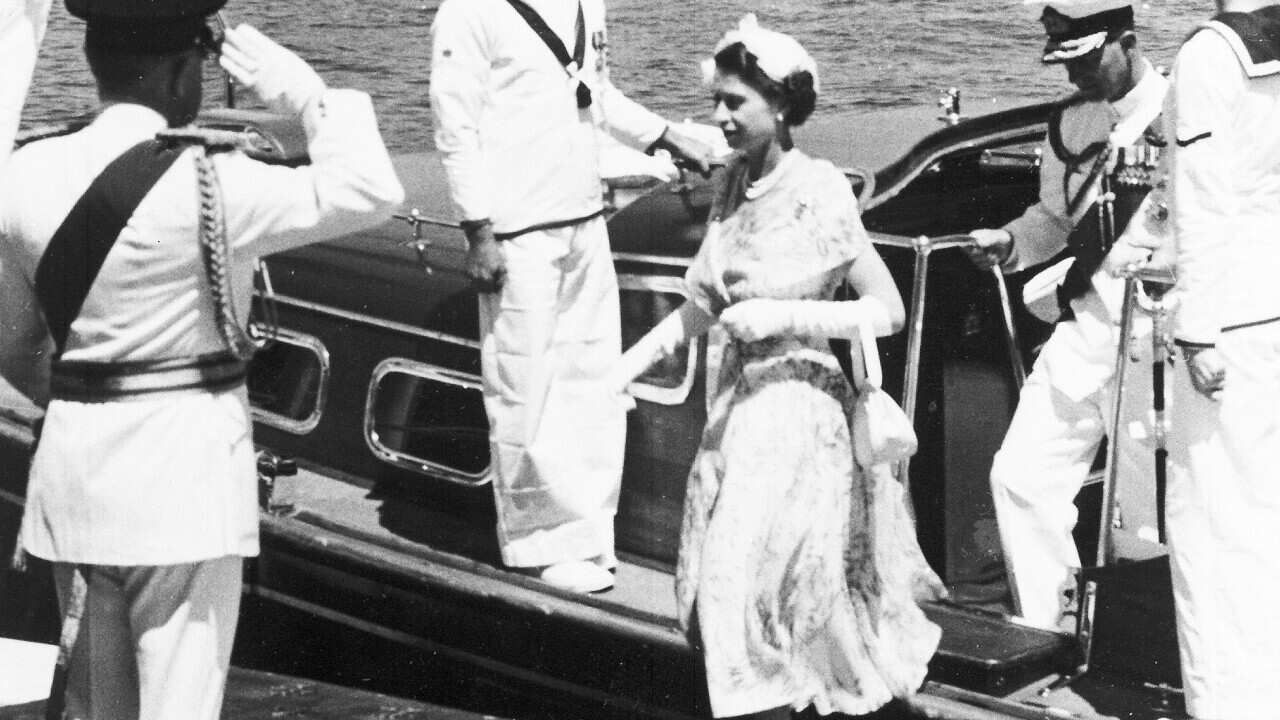 Britain's Queen Elizabeth II, followed by her husband Duke of Edinburgh, steps ashore from the tender at Farm Cove, Sydney, on Feb. 3, 1954.