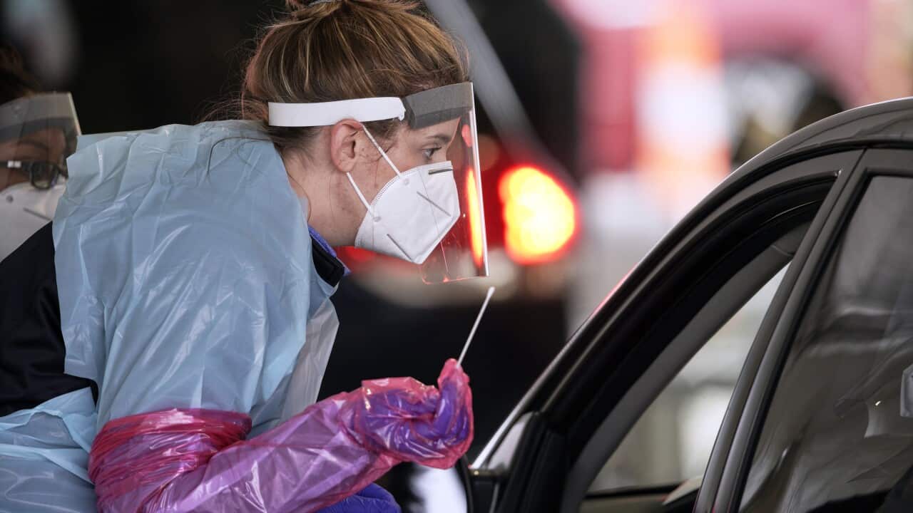 A nurse at a drive-thru location in Nebraska holds prepares to administer a test for the coronavirus.