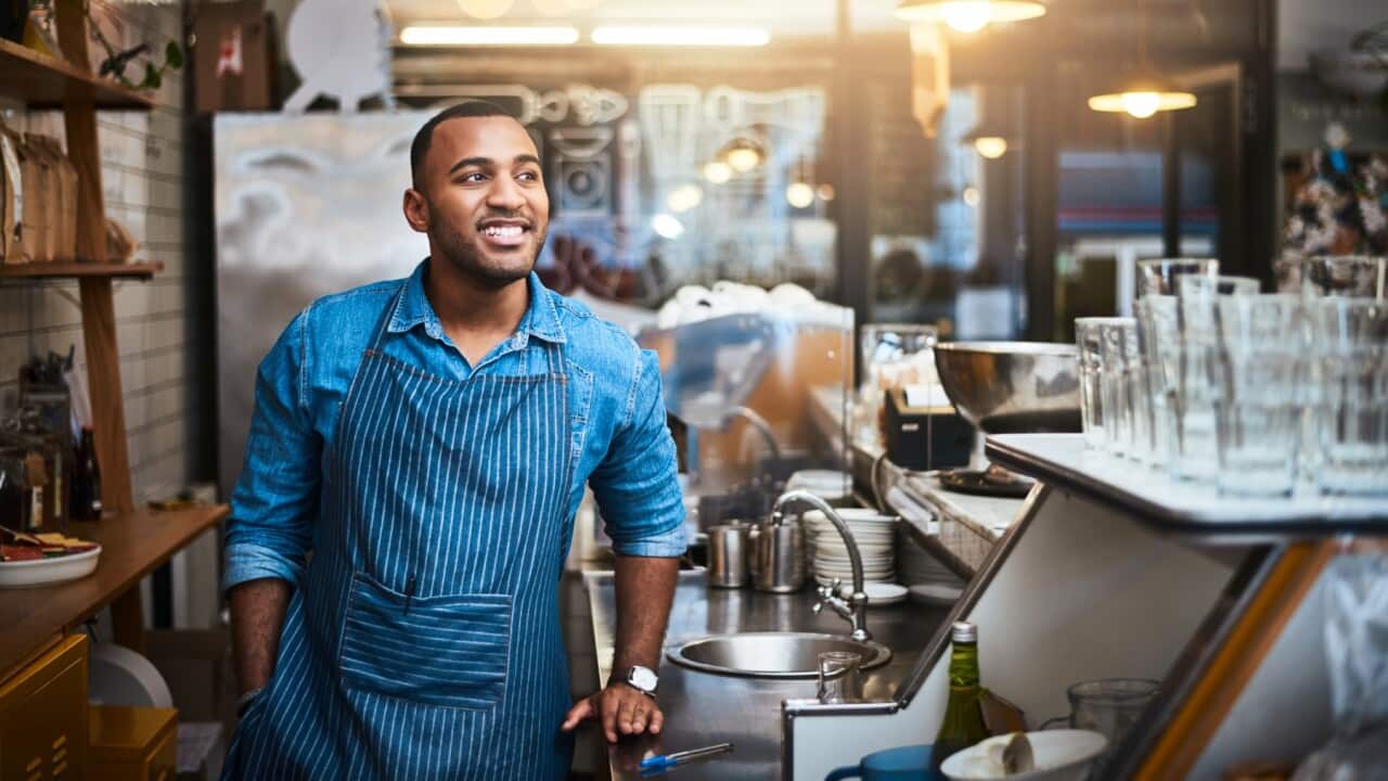 Man standing in the kitchen of a restaurant.