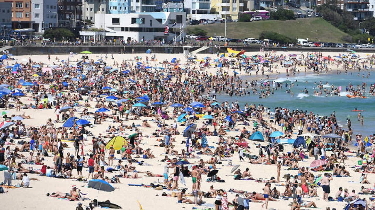 Beachgoers spend Christmas Day on Bondi Beach, in Sydney, Sunday, Dec. 25, 2016. (AAP Image/Dan Himbrechts) NO ARCHIVING