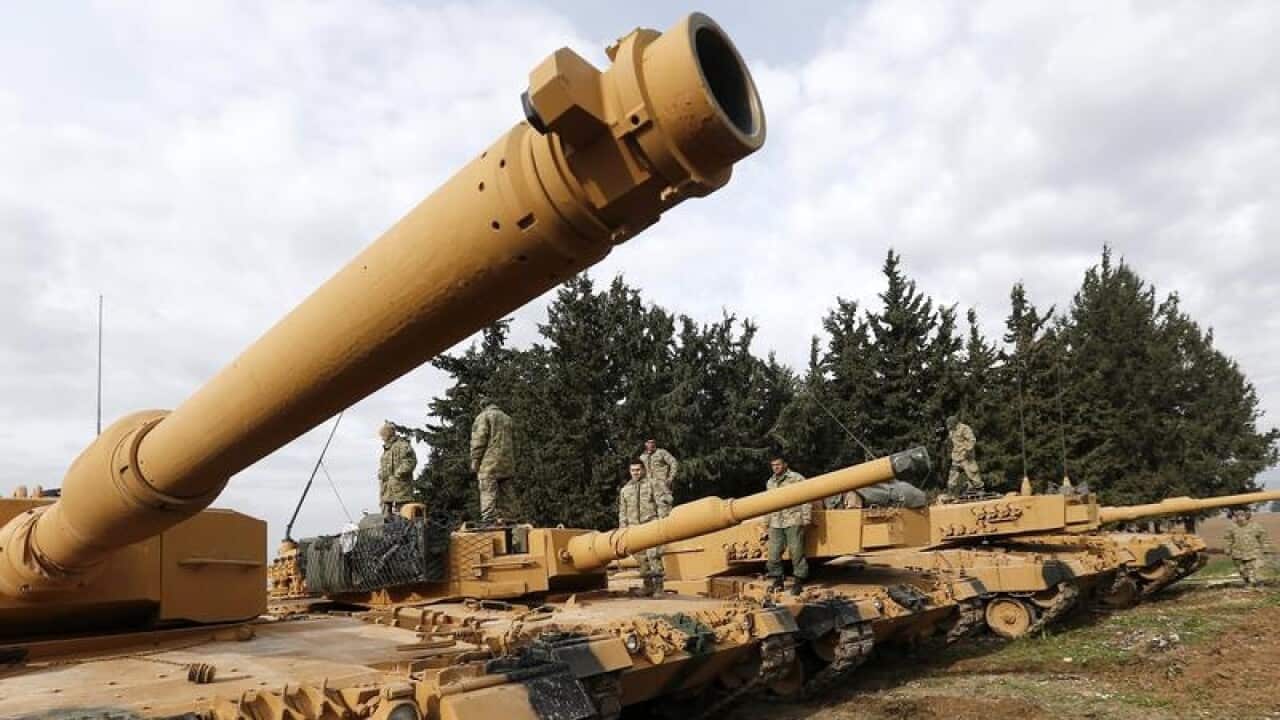 Turkish soldiers prepare tanks near the Syrian-Turkish border