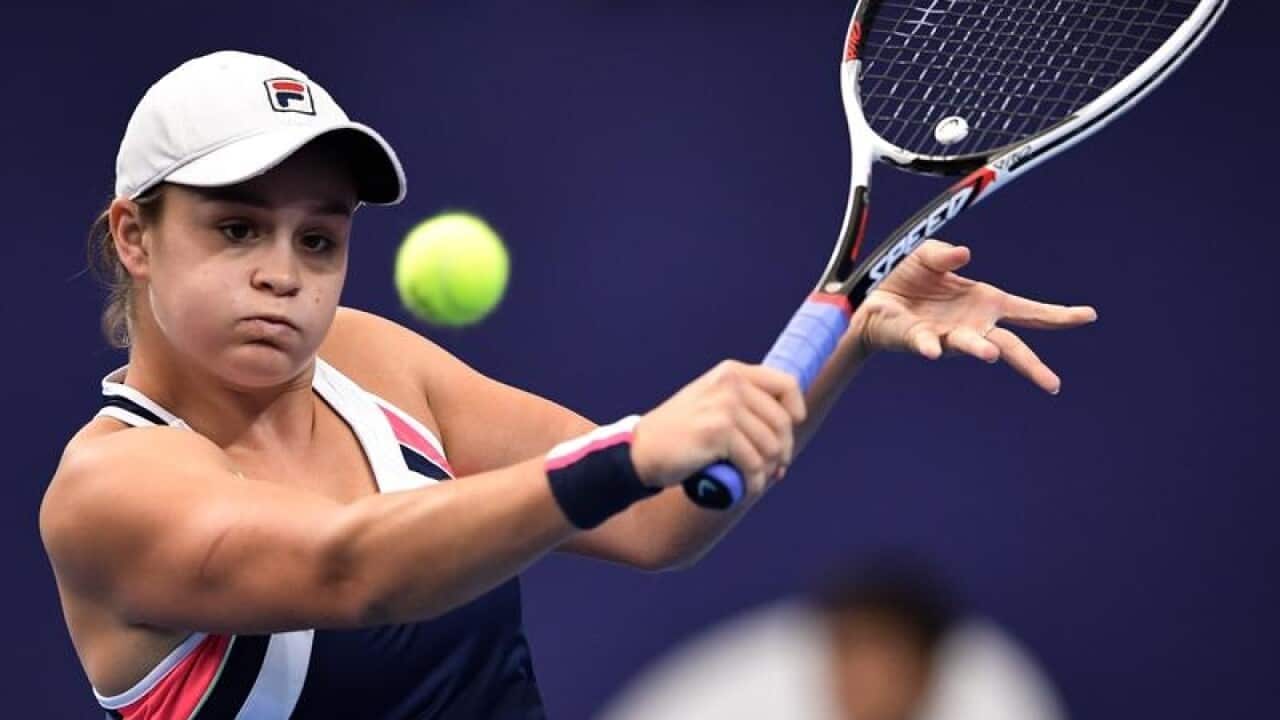 Ashleigh Barty of Australia returns a shot to Angelique Kerber.