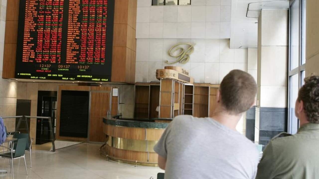 People watching the information boards as the ASX in Sydney