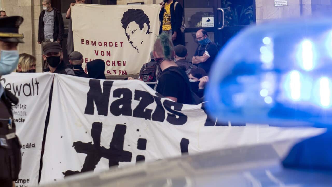 People attend an anti-racism demonstration in Dessau, Germany, Thursday, June 11, 2020. 20 years after Mozambican Alberto Adriano's violent death by neo-Nazis, people commemorate the victims of racism and right-wing extremism. (AP Photo/Jens Meyer)
