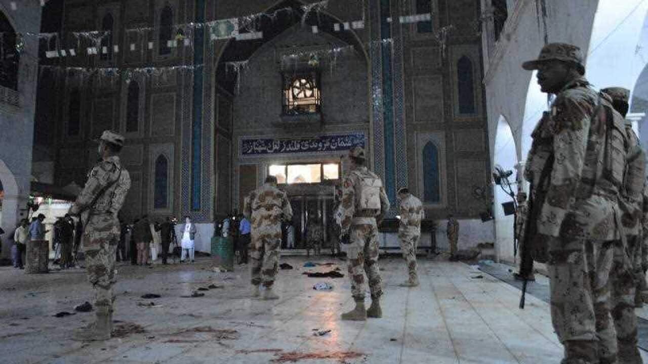 Pakistani para-military soldiers stand alert after a deadly suicide attack at the shrine of famous Sufi Lal Shahbaz Qalandar in Sehwan, Pakistan