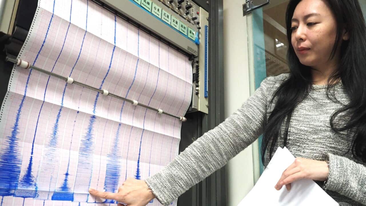 Tsai Min-chien points to a graph after three earthquakes