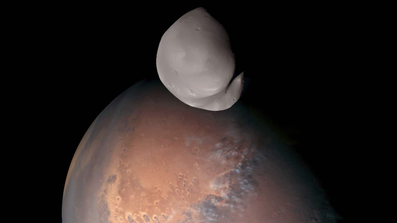 Composite image provided by the UAE Space Agency shows Mars’ moon Deimos in the foreground