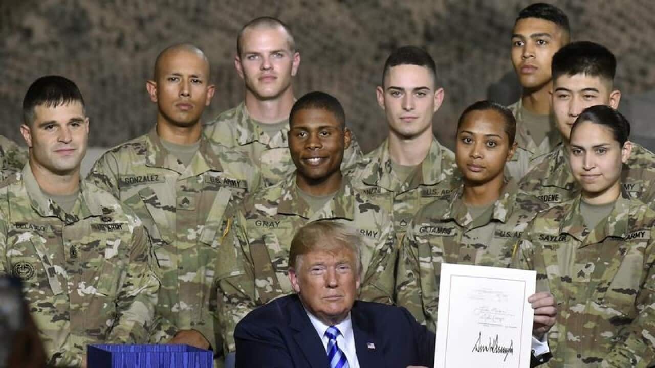 Donald Trump with the John McCain National Defense Authorization Act