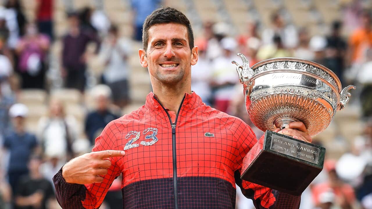 Novak Djokovic of Serbia celebrates with the Roland Garros trophy, on June 11, 2023