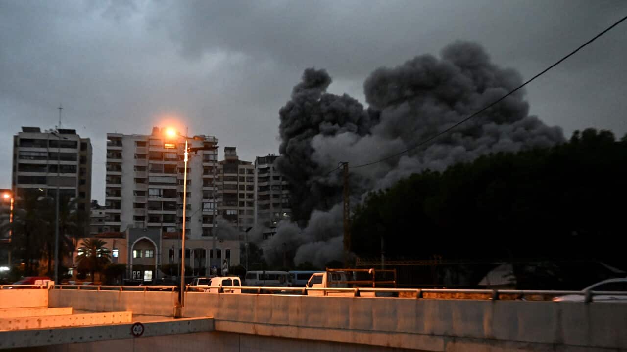 A huge plume of smoke rises from an apartment building following an airstrike